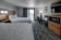 Hotel room with two beds, seating area and television